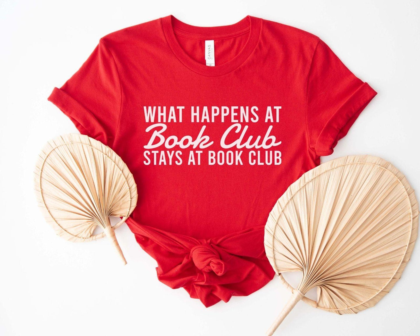 A comfort colors® shirt with the saying "what happens at book club stays at book club"