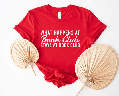 A comfort colors® shirt with the saying "what happens at book club stays at book club"