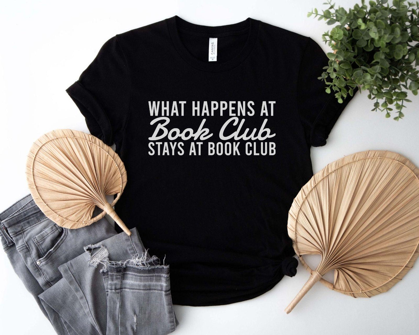 A comfort colors® shirt with the saying "what happens at book club stays at book club"