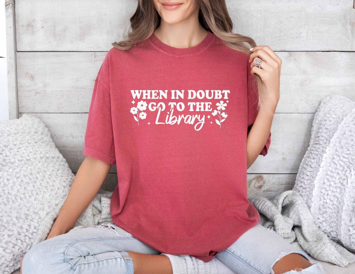 A comfort colors shirt with the saying "When in doubt go to the library"