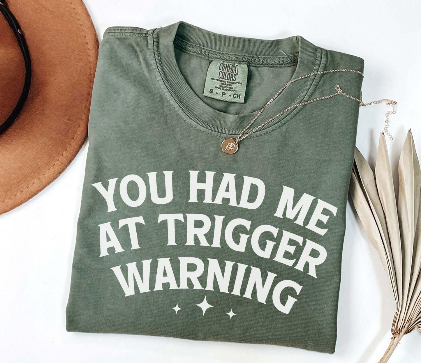 A comfort colors® shirt with the saying "you had me at trigger warning"