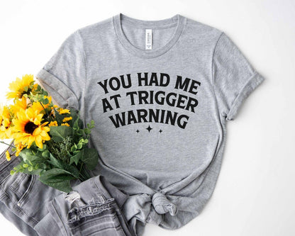 A bella canvas 3001 shirt with the saying "you had me at trigger warning"