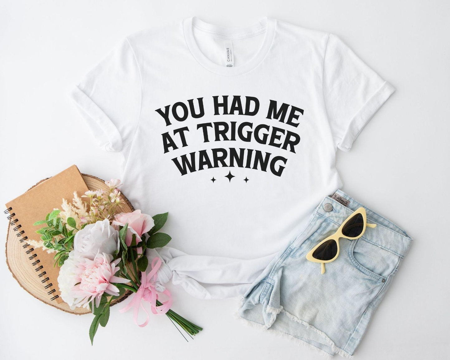 A bella canvas 3001 shirt with the saying "you had me at trigger warning"