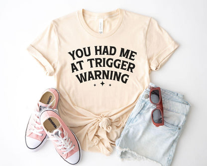 A bella canvas 3001 shirt with the saying "you had me at trigger warning"
