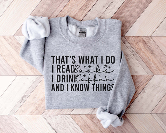 A sport grey color sweatshirt with the saying "that's what I do I read books I drink coffee and I know things"