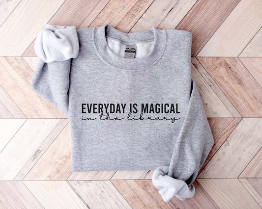 A sport grey color sweatshirt with the saying "Everyday is magical in the library"