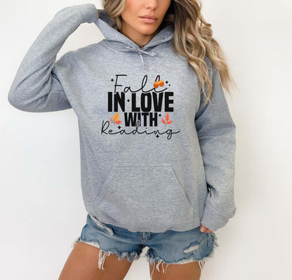 Person wearing a sport grey hoodie with 'Fall in Love with Reading' text on a white background